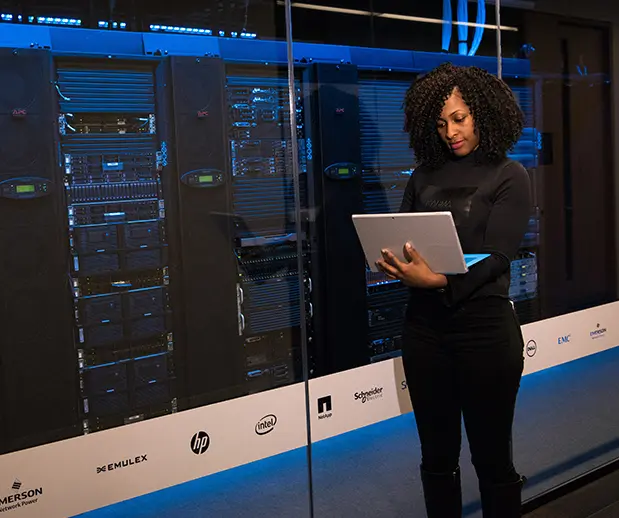 Female Professional With Laptop in Hand at Data Center